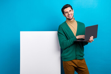Aufkleber - Photo of young man programmer make purchase online eshopping buyer advert photo placard hold netbook isolated on blue color background