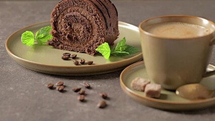 Canvas Print - Coffee cup and chocolate roll cake on a table. Sweet breakfast.