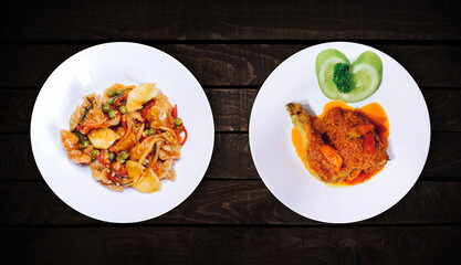 Wall Mural - Side dish, sweet spicy chicken dish is on white plate on dark wooden background, top view.