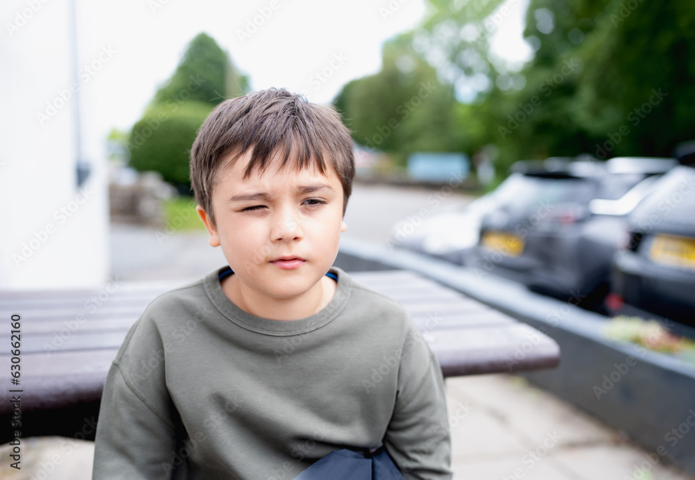 Portrait Young boy looking out deep in thought, School kid sitting ...