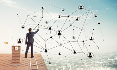 Wall Mural - Businessman on house roof presenting networking and connection c