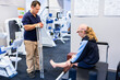 © Austockphoto - Physiotherapist working with teen girl teaching her how to use crutches  to walk with only one