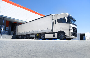 white truck loading in front of the warehouse