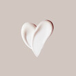 cosmetic smear of cream in the shape of heart on beige background