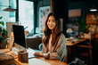 © Creative Clicks - Photo of Cheerful asian female freelancer in workspace
