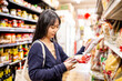© Austockphoto - 20-something Asian woman shopping buying groceries at a supermarket