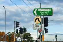 Turn Left At Any Time With Care And Pedestrian Crossing Sign At Traffic Lights With Directions