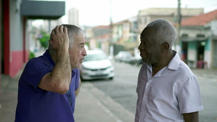 Diverse Elderly People in Candid City Street Conversation, two diverse Brazilian seniors talking interaction in urban setting