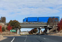 Blue Truck Passing On Overhead Overpass Bridge With Road Sign Along Hume Highway To Goulburn