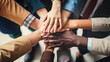 © MP Studio - Close up view from above of young business people putting their hands together. Created with Generative AI technology.