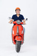 © 1112000 - full body photo of a man wearing a hairdresser and driving a motorbike