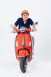 © 1112000 - full body photo of a man wearing a hairdresser and driving a motorbike