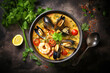 Delicious shellfish and fish soup on a concrete background