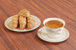 top view croissants in white plate on wooden table with hot tea drink isolated on brown background,bread ready for breakfast.