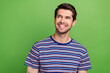 Photo of candid sincere man with stubble dressed striped stylish clothes look at dental ad empty space isolated on green color background