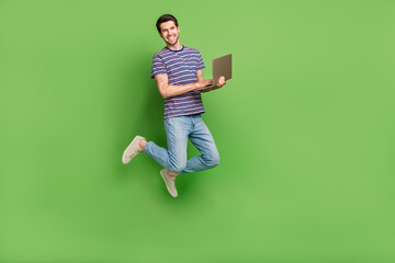 Aufkleber - Full length photo of cheerful positive guy wear striped t-shirt jumping texting twitter telegram facebook isolated green color background