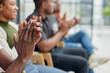 © Katsiaryna - Group of men and women sit in a row and applaud a man who puts forward an idea or says something.
