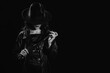 © alexkoral - Sexy female dominant mistress with a whip for BDSM sex with submission and domination in a leather raincoat and a hat in the noir style