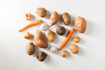 Wall Mural - food, eating and culinary concept - close up of different raw vegetables on white background, top view