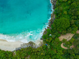 Fototapeta Natura - .aerial top view amazing freedom beach small white sand beach with perfect nature. .white wave hit the rock around island. .green forest peaceful. green sea, and clear sand landscape. Paradise beach..