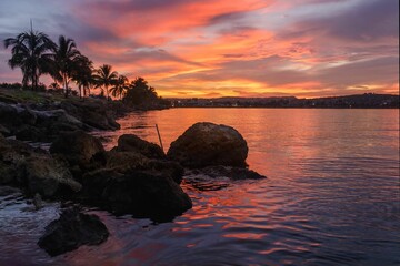 Wall Mural - Vibrant sunset over the tranquil water. Matanzas, Cuba.