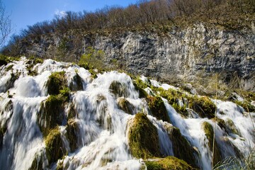 Sticker - Beautiful cascading waterfall in a lush forested area in Plitvice National Park, Croatia