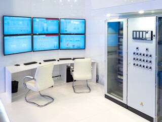 Poster - dispatch center of enterprise. desk for dispatchers. several monitors above table. load monitoring c