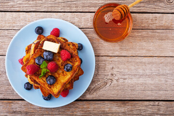 Wall Mural - French toast with berries and honey