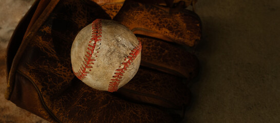 Wall Mural - Old used vintage baseball glove with copy space on retro texture background.