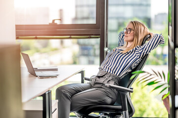 Relax at work. A young woman is relaxing in the office. End of the working week.