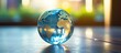 © HN Works - A close-up image of a glass globe placed on a table, with a copy space background for adding text. The picture relates to global network business technology, environment day, and world health day