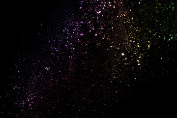 Wall Mural - abstract colored dust explosion on a black background.abstract powder splatted background,Freeze motion of color powder exploding/throwing color powder, multicolored glitter texture.