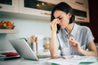 © My Ocean studio - Overworked. Deadline. Close up photo of stressed business woman working from home on laptop looking worried, tired and overwhelmed