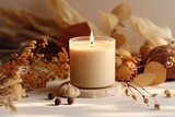 A vanilla scented candle is being burned on a beige background, creating a cozy and warm autumn atmosphere with dried leaves and flowers. This composition represents the comforts of home, spa