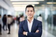 © Moritz - Leader in Innovation: High-Resolution Portrait of a Young Tech CEO Standing in a Bustling Office