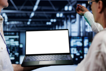 Poster - Close up shot of mock up laptop used by professional mechanic in data center server room delivering massive computing power, capable of processing and storing vast amounts of datasets