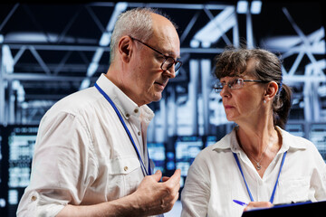 Poster - Octogenarian managers brainstorming ways to service server room components. Skillful supervisors brainstorming ideas on how to best minimize high tech establishment downtime and prevent defects