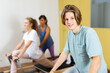 © JackF - Teenagers boy and girl practicing Pilates system on reformer supervised in gym