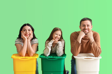 Wall Mural - Family with recycle bins on green background