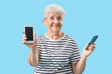 Sticker - Senior woman with mobile phones on blue background