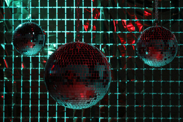 Canvas Print - Shiny disco balls against foil party curtain under color lights