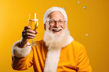 Elderly Santa Claus In A Yellow Suit Toasting With A Beer Mug In A Studio On A Yellow Background. Merry Christmas