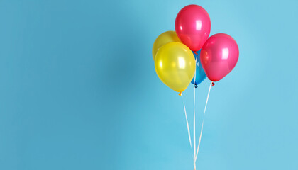 Bunch of bright balloons on light blue background, space for text. Banner design