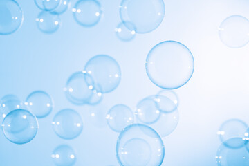 Beautiful Transparent Blue Soap Bubbles Floating in The Air. White Space, Abstract Fun Background, Blue Gradient Blurred Background, Refreshing of Soap Suds Bubbles Water.