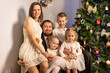 © Evgenia Tiplyashina - christmas family near christmas tree