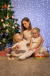 © Evgenia Tiplyashina - christmas family near christmas tree