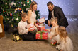 © Evgenia Tiplyashina - christmas family near christmas tree