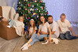 © Evgenia Tiplyashina - christmas family near christmas tree