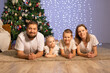 © Evgenia Tiplyashina - christmas family near christmas tree