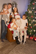 © Evgenia Tiplyashina - christmas family near christmas tree